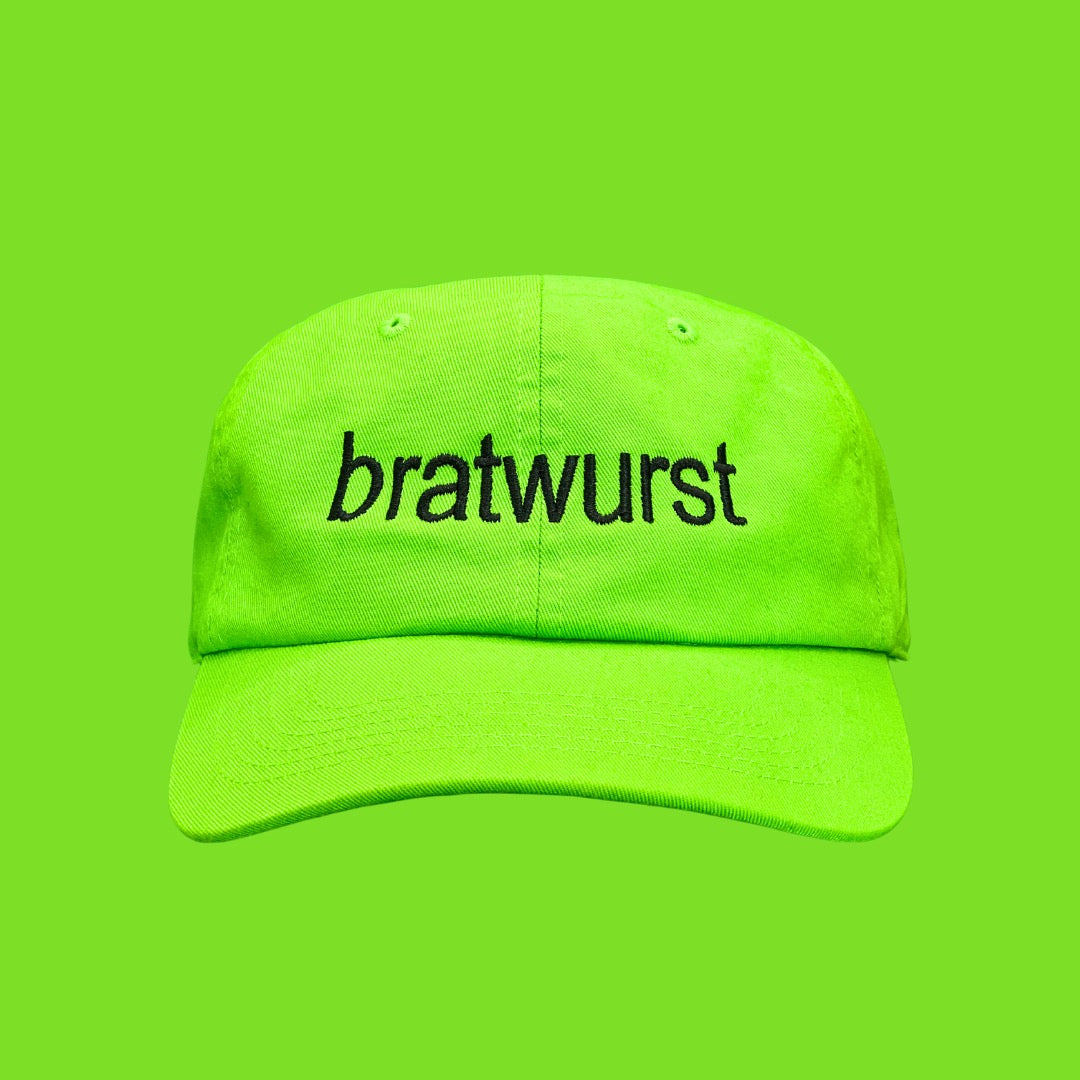 A lime green 100% cotton dad hat with black text that says "Bratwurst"